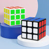 A set of colorful frosted 3x3 magic cubes stacked on a blue and white surface.