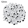A pile of small white plastic safety eyes for crafting and stuffed animals.