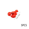 A bright red plastic toy of a marine creature, likely an octopus or crab, used as a building block.