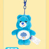 A blue Care Bears plush keychain charm with a purple hook and a white tag.