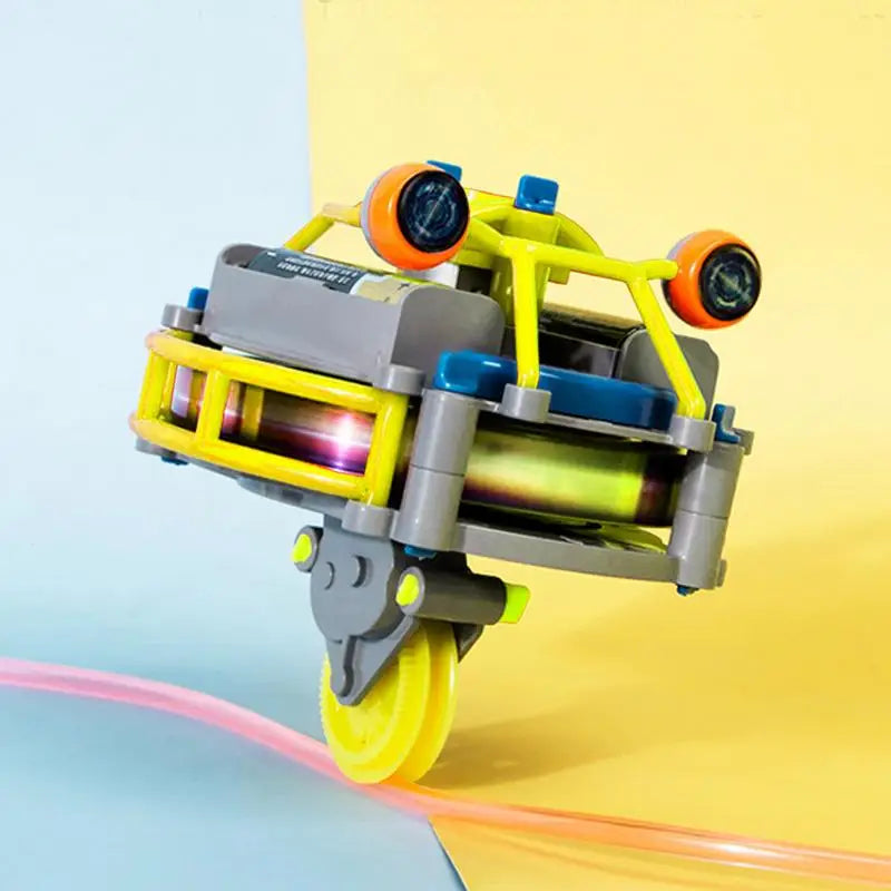 A yellow and gray gyroscopic unicycle fingertip spinner with orange and blue accents.