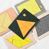 A collection of colorful wooden geometric brain teaser puzzles in various shapes and sizes.