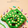 A green rabbit trap puzzle game board with various colorful plastic rabbit pieces and cards scattered around it.