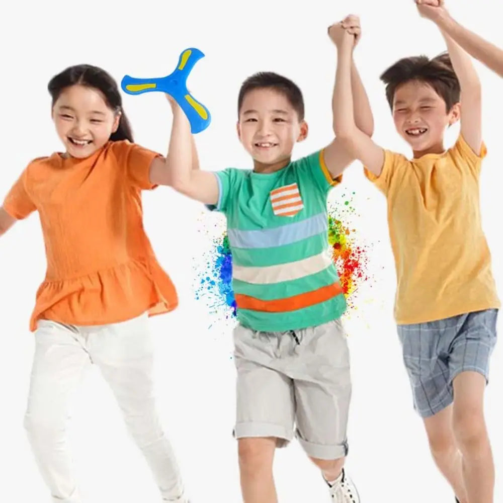 Three children playing with a blue soft foam boomerang flying disc outdoors.