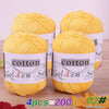 Four balls of yellow cotton knitting yarn for crochet and handmade projects