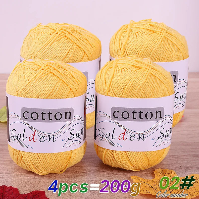 Four balls of yellow cotton knitting yarn for crochet and handmade projects