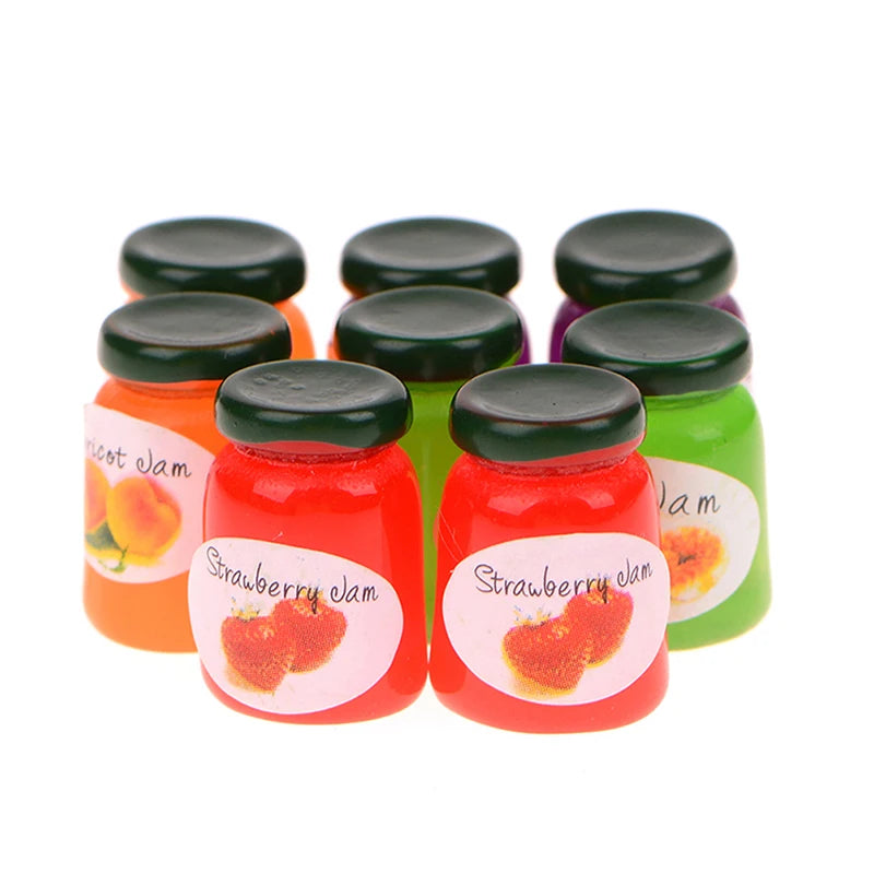A set of five miniature ceramic jam jars with black lids, featuring strawberry jam in various colors.