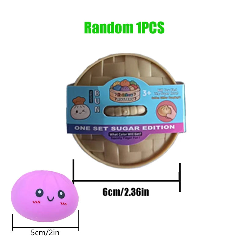 A round beige squishy toy shaped like a dumpling, with a pink spherical version shown next to it.