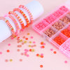 A box of colorful clay and alphabet beads for DIY jewelry making, displayed next to beaded bracelets.