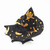 A black witch hat with gold accents and a matching fabric accessory for a Halloween costume set.