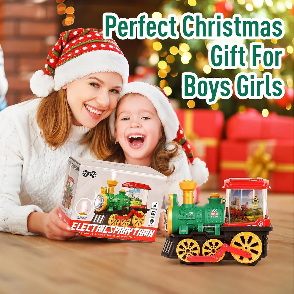 A child is holding a green electric steam train toy with lights and sounds in front of a Christmas background.