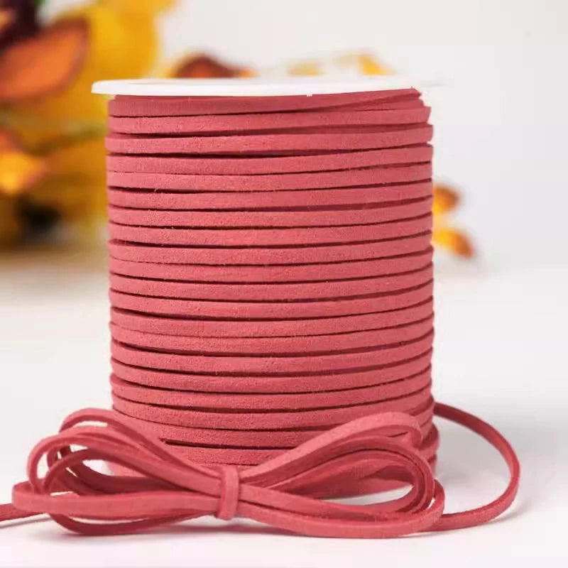 A roll of reddish-pink velvet faux suede braided ribbon for crafting and gift wrapping.