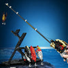 A fishing rod building blocks set with a reel is shown being assembled on a surface against a blue background.