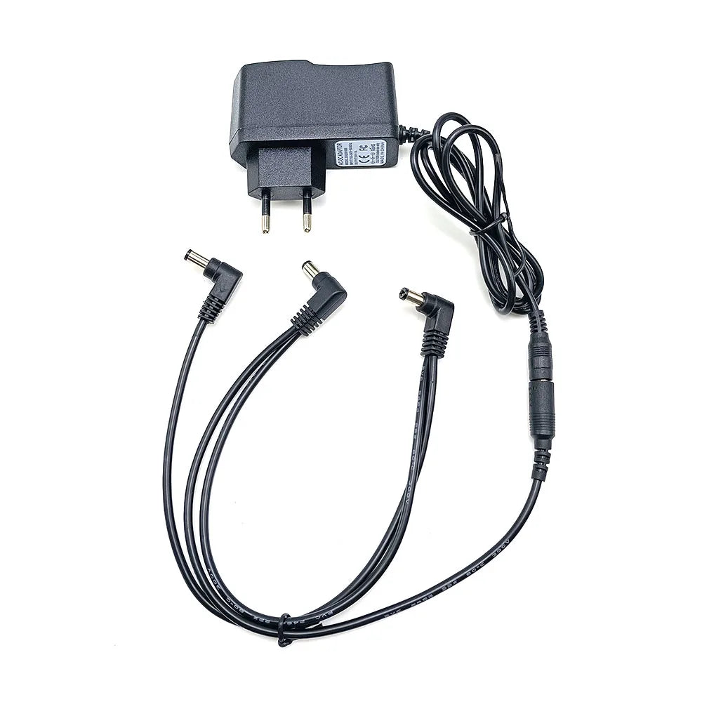 A black power supply adapter for a guitar pedal, featuring a plug and multiple cables.
