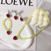 A set of five princess jewelry accessories including earrings, necklaces, and a yellow beaded bracelet displayed on a white s