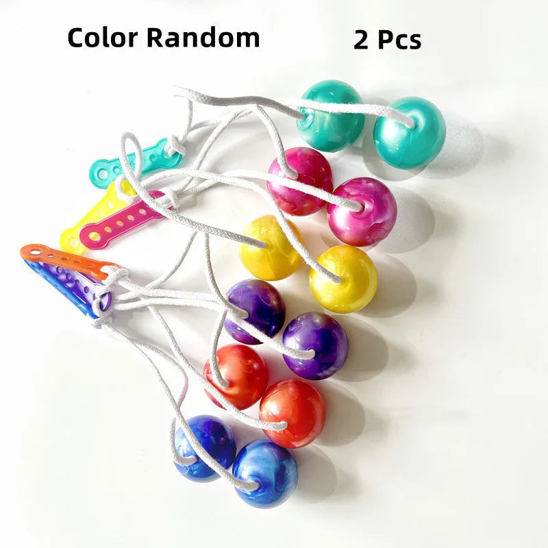 Two colorful fidget balls are tied together on a string for stress relief