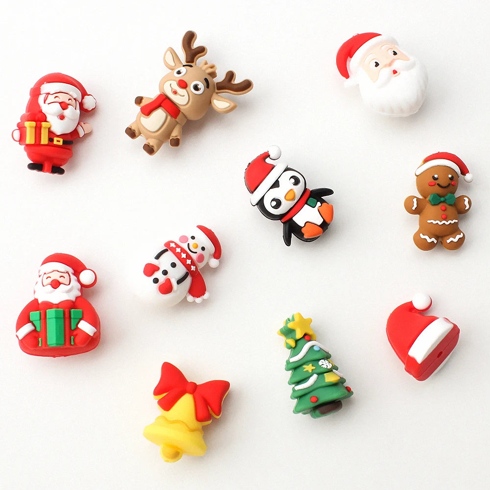 A collection of silicone beads featuring various Christmas and Santa-themed charms including a Santa face, reindeer, and Chri