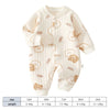 Combinaison en coton couleur crème pour nourrissons avec un motif de petits visages d'ours.