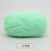 A ball of light green pre-dyed milk cotton yarn used for knitting and crochet.
