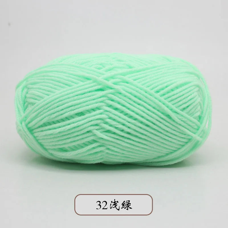 A ball of light green pre-dyed milk cotton yarn used for knitting and crochet.