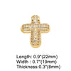 A gold-toned crystal heart cross pendant with dimensions 0.9 inches long, 0.7 inches wide, and 0.3 inches thick.