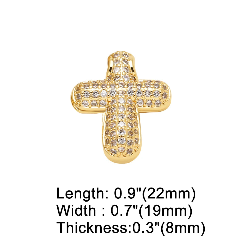 A gold-toned crystal heart cross pendant with dimensions 0.9 inches long, 0.7 inches wide, and 0.3 inches thick.