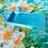 A light blue diamond painting organizer tray with storage compartments placed on a colorful fabric background.