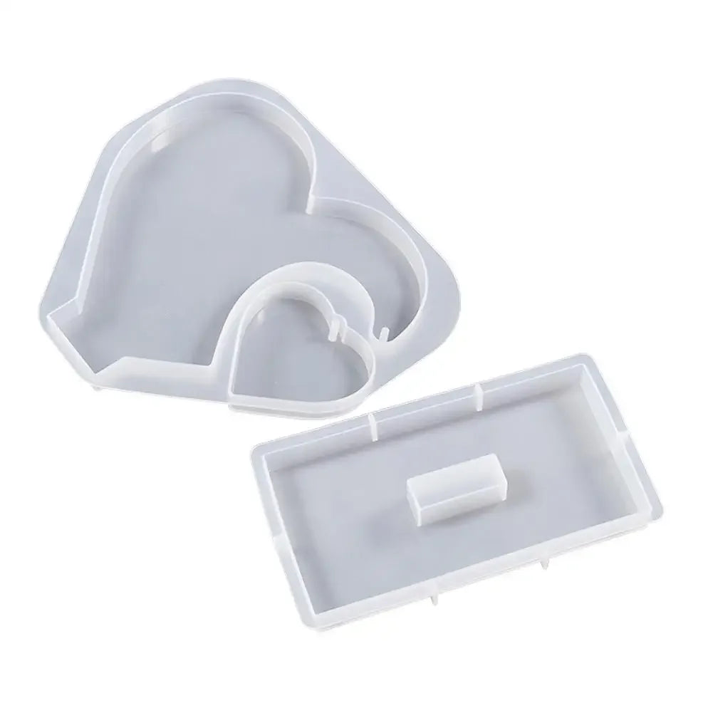 White silicone resin molds shaped like a heart and a rectangular frame for DIY craft gifts