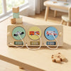 A wooden Montessori busy board for toddlers featuring numbered gears and switches with LED lights.