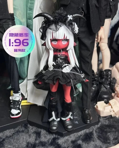 A detailed vinyl art figure of a female character with white hair, red eyes, and black gothic clothing and horns.