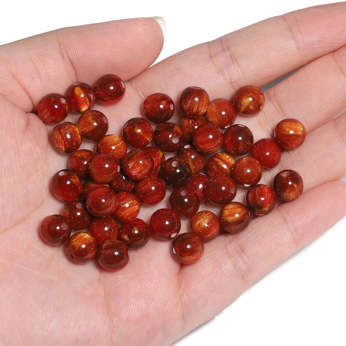 A handful of vibrant reddish-brown tiger eye resin beads for jewelry making