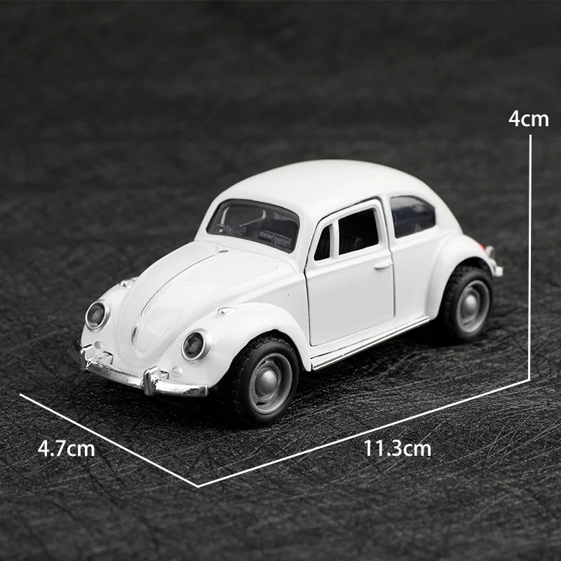 A white 1:38 die-cast model of a classic Beetle car shown from the side.