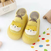 A pair of yellow animal soft sole sock shoes for babies and toddlers with cute cat designs