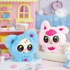 A plush toy featuring a blue face and pink accents sits next to a pink fluffy creature with large eyes.