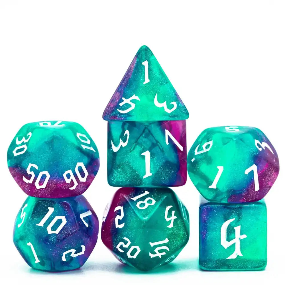 A set of seven glitter translucent polyhedral dice in various colors and shapes