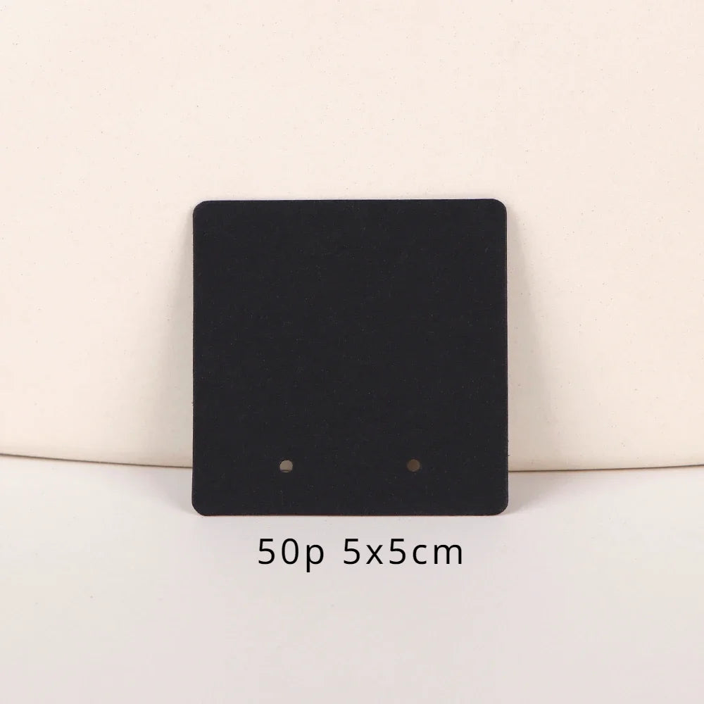 A black square jewelry display card with two holes, labeled 50p 5x5cm.