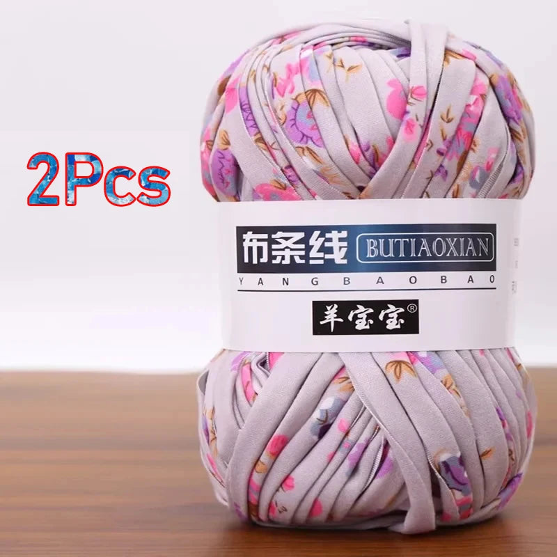 Two skeins of soft chunky t-shirt yarn in lilac and pink floral patterns for crochet and knitting