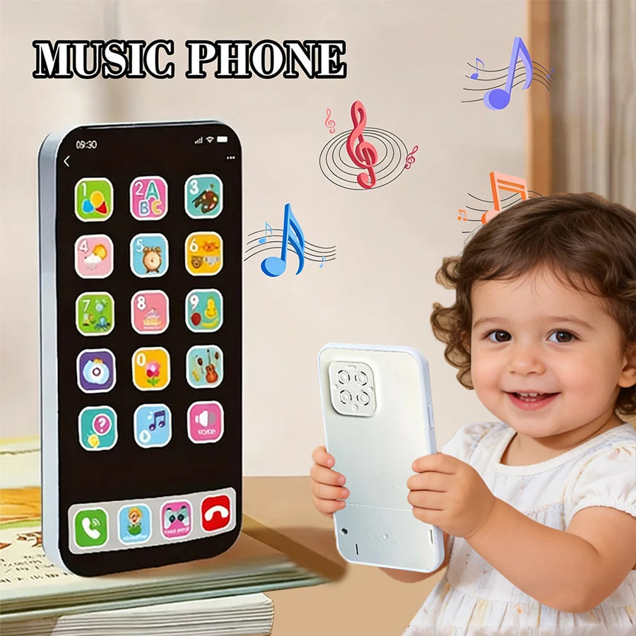 A baby is holding a white interactive learning phone toy with music and stories displayed on the screen.