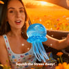 A woman holds a blue jellyfish squish toy in the car, set against a sunset background.