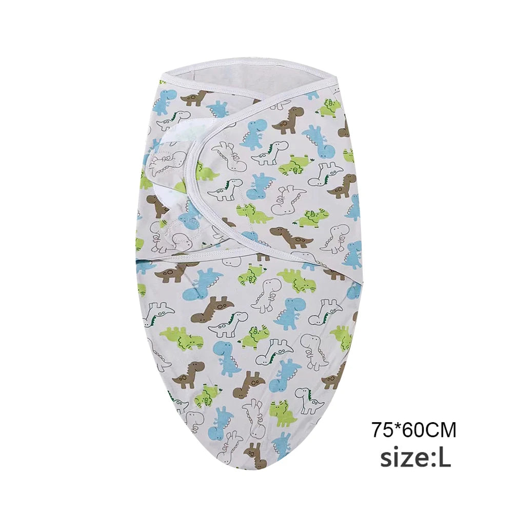 A white cotton newborn swaddle blanket featuring a pattern of various cute dinosaur and animal figures in blue, green, and br