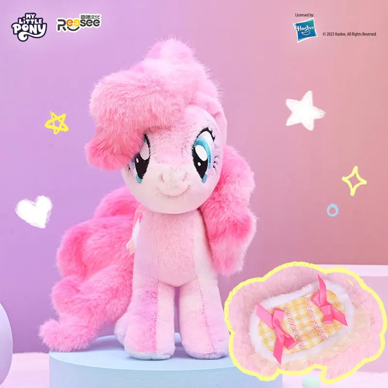 A pink My Little Pony plush pendant featuring a detachable saddle, displayed against a light purple background.