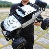 A person holds a white and black high-speed 4WD off-road RC truck with large tires and LED lights.