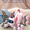 A pink remote control stunt robot dog with large wheels is shown lying on a fluffy surface.