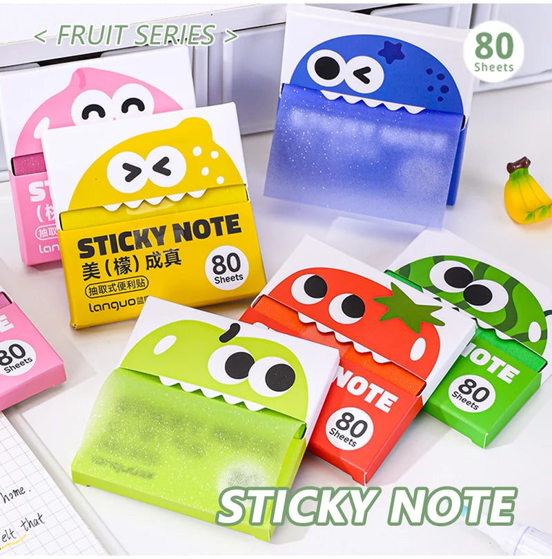 A collection of pearlescent clear sticky notes in various colors and a blue dispenser are displayed on a white surface.