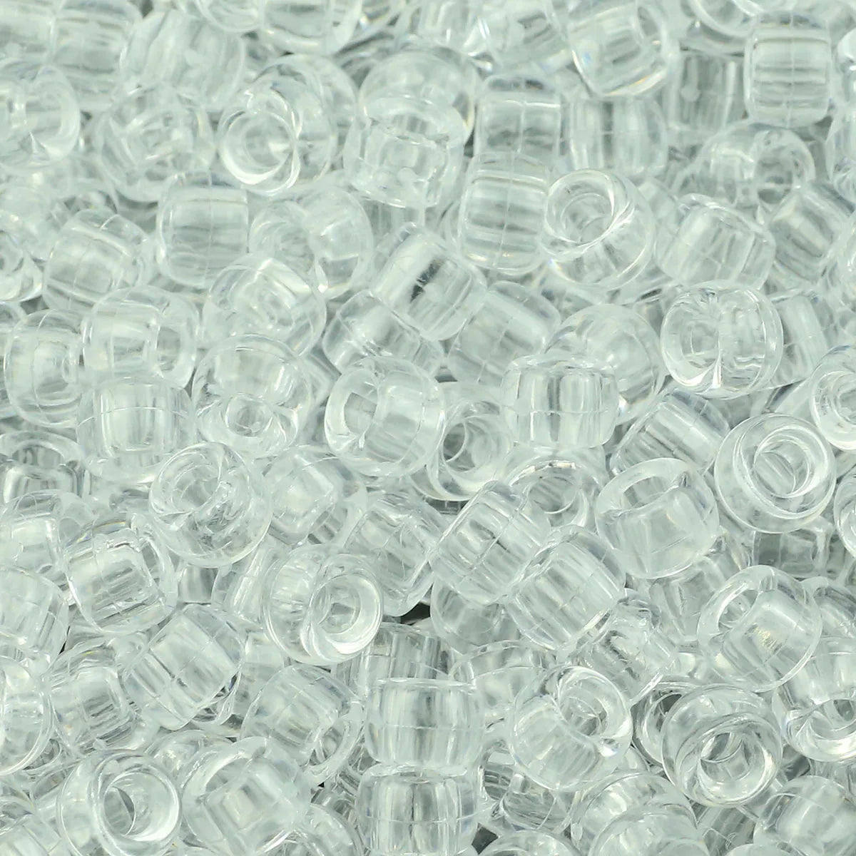 A close-up view of clear, round pony beads for jewelry making and crafts.