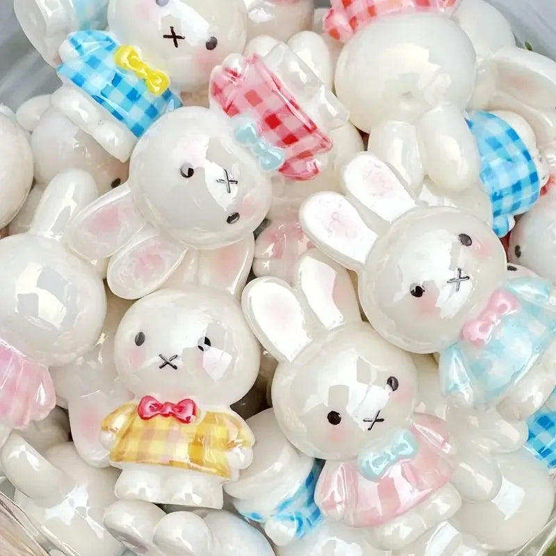 A collection of white and pink Miffy 3D resin bead phone charms and keychains.
