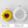 A yellow silicone mold shaped like a sunflower is shown next to its finished product, demonstrating the size and weight.