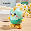 A cute green chick toy with yellow feet sitting on a wooden surface.