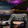 A gray remote control device is shown with a screen displaying a scenic view, set against a backdrop of a car and racing equi