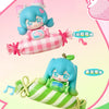 A blind box figure of Hatsune Miku in a pink and green striped candy theme, featuring a cute face and accessories.